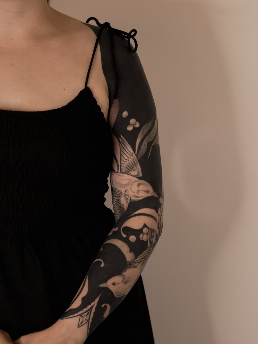 Elegant Black Sleeve Tattoo with Nature Motifs