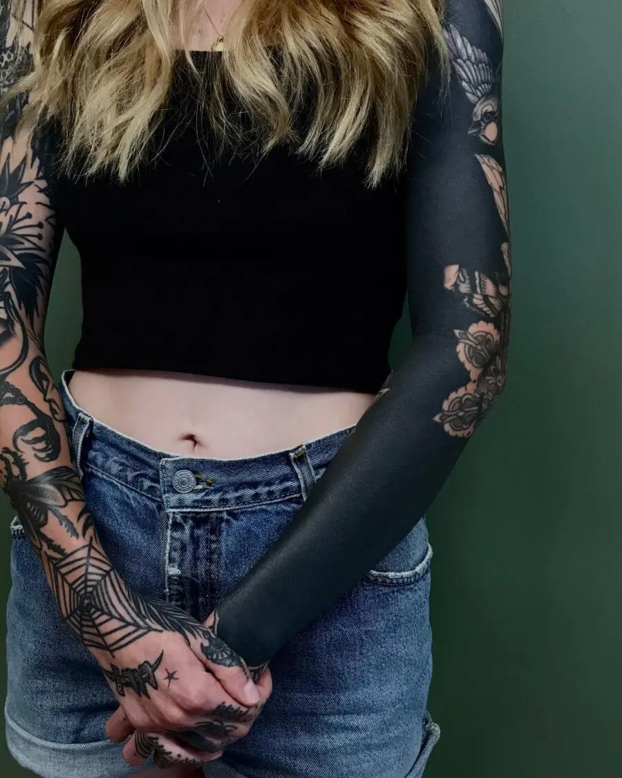 Stunning black sleeve tattoo with floral details