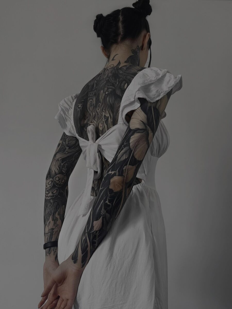 Elegant black sleeve tattoo with floral accents