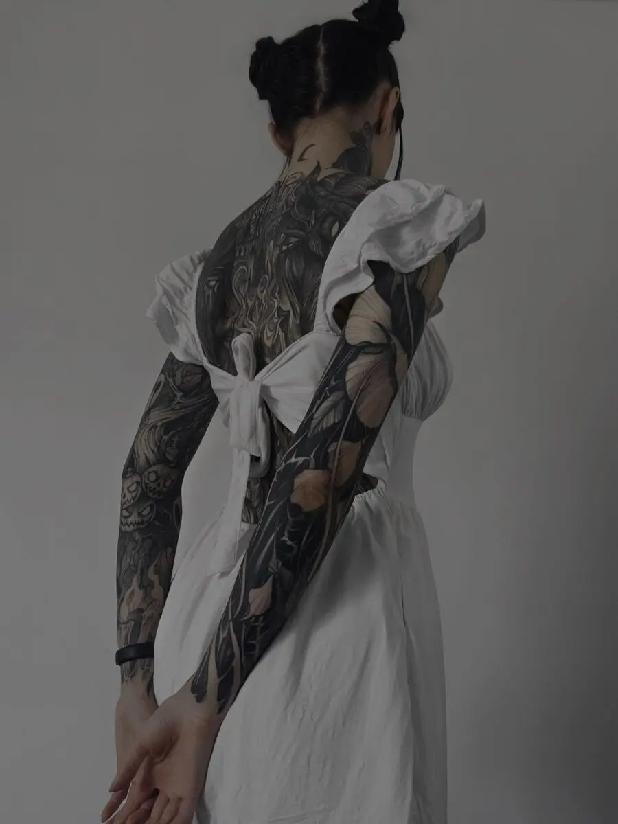 Elegant black sleeve tattoo with floral accents