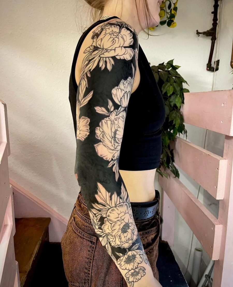 Elegant black floral sleeve tattoo design
