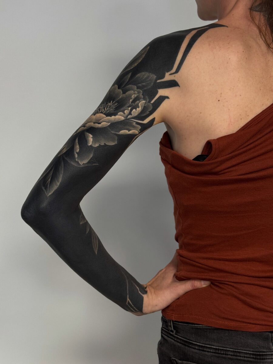 Elegant black floral sleeve tattoo inspiration