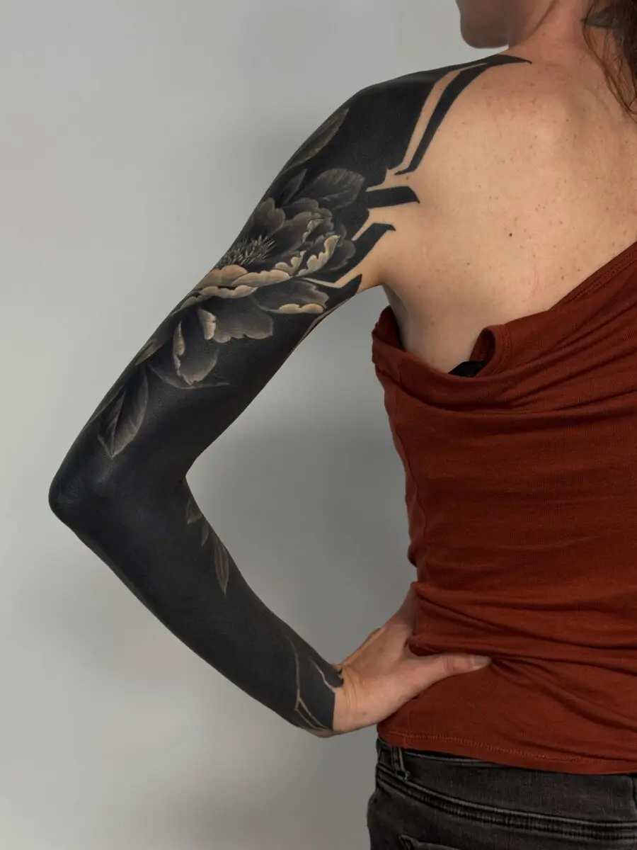 Elegant black floral sleeve tattoo inspiration