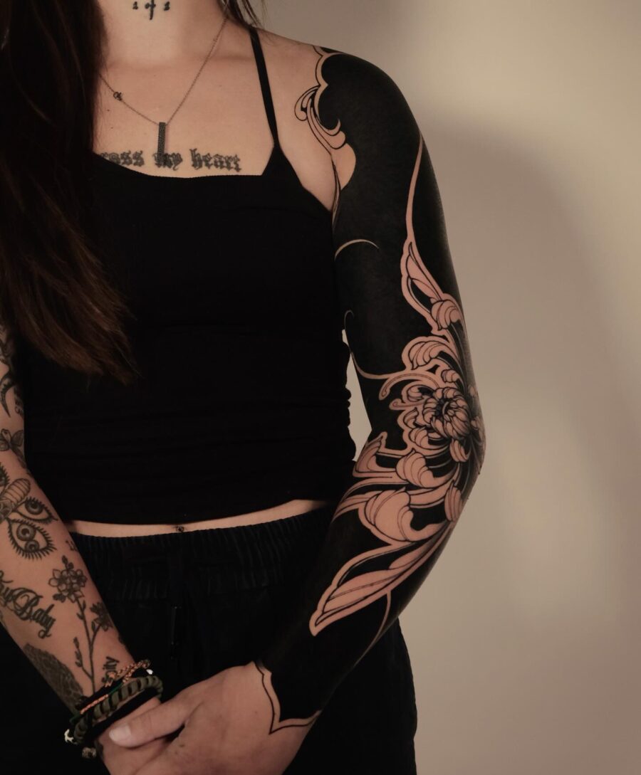 Bold floral motifs adorn a striking black sleeve