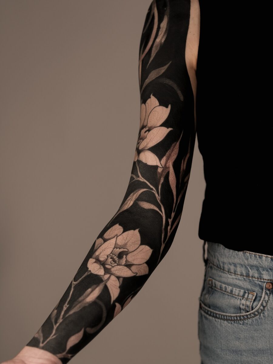 Elegant floral black sleeve tattoo design