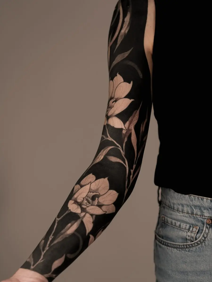 Elegant floral black sleeve tattoo design