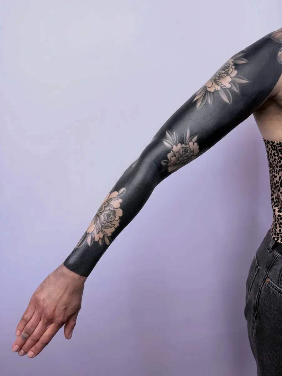 Stunning black floral sleeve tattoo design