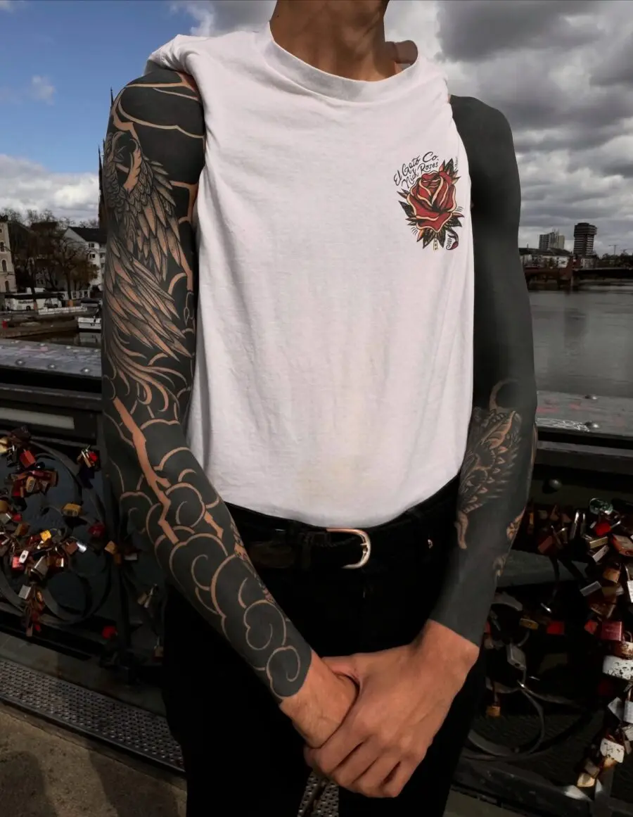 Bold black sleeve tattoo showcasing intricate designs