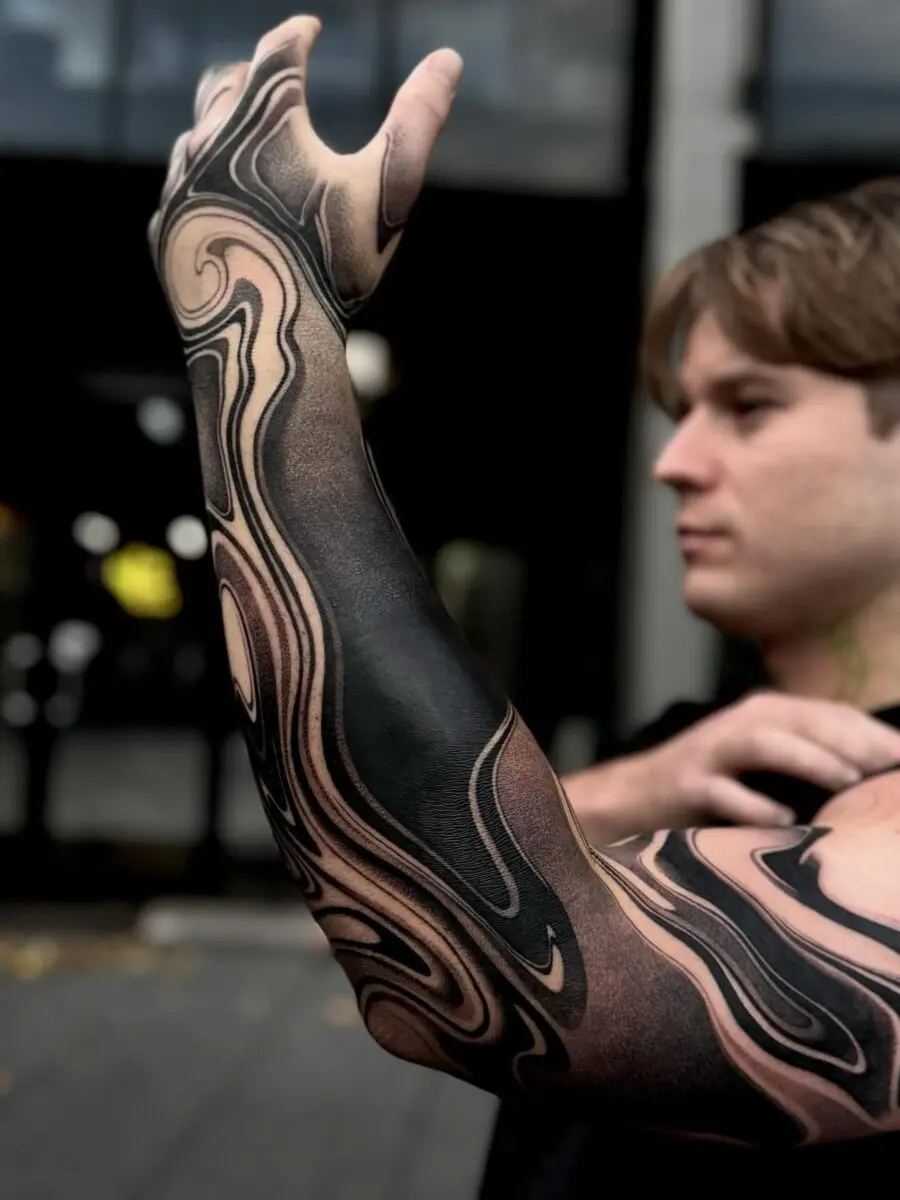 Dynamically swirling black sleeve tattoo design