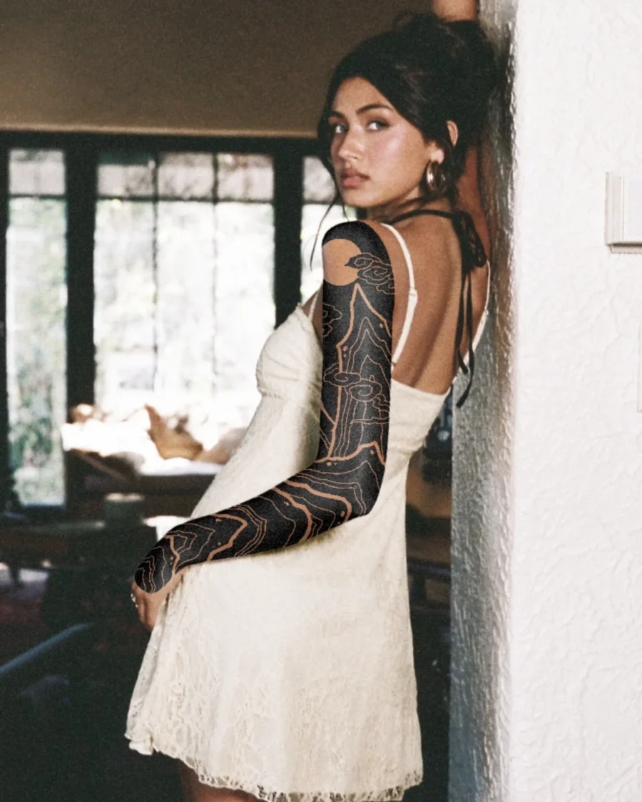 Elegant black sleeve tattoo on stylish model