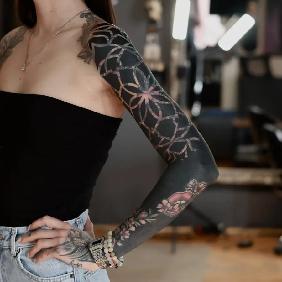 Elegant floral black sleeve tattoo design