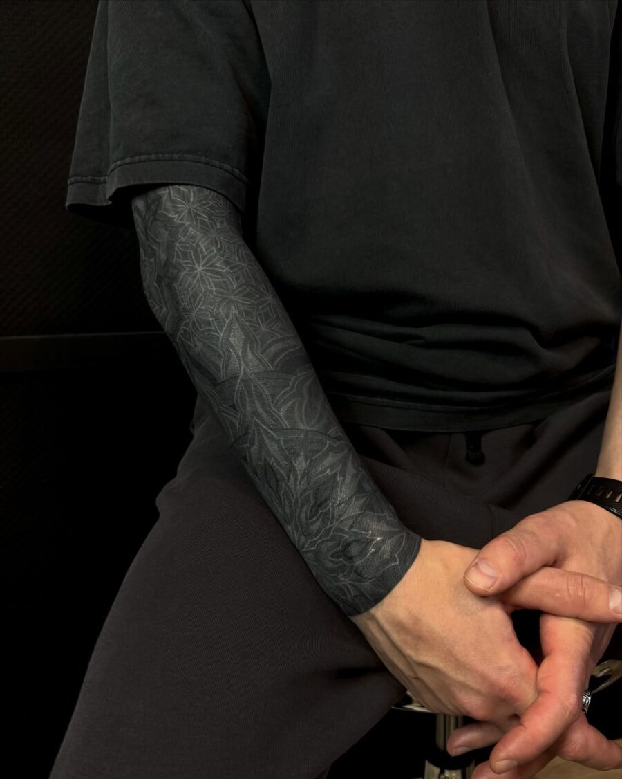 Intricate black sleeve tattoo design showcased elegantly