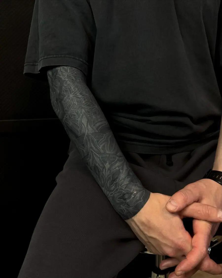 Intricate black sleeve tattoo design showcased elegantly