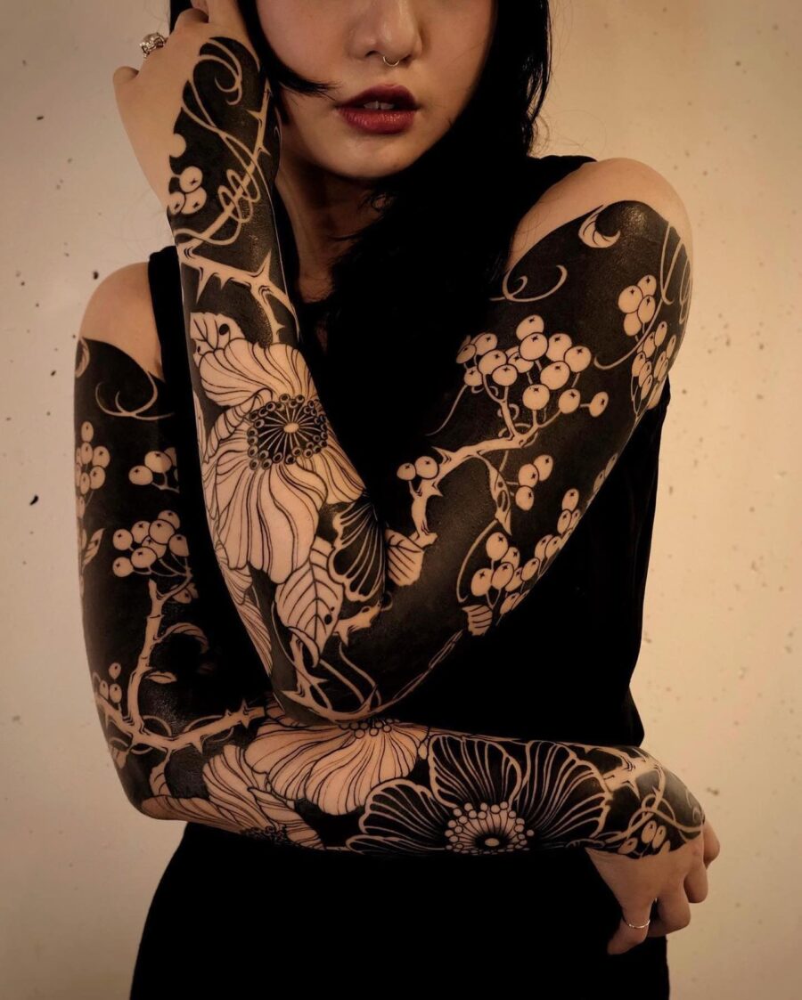 Intricate floral black sleeve tattoo design