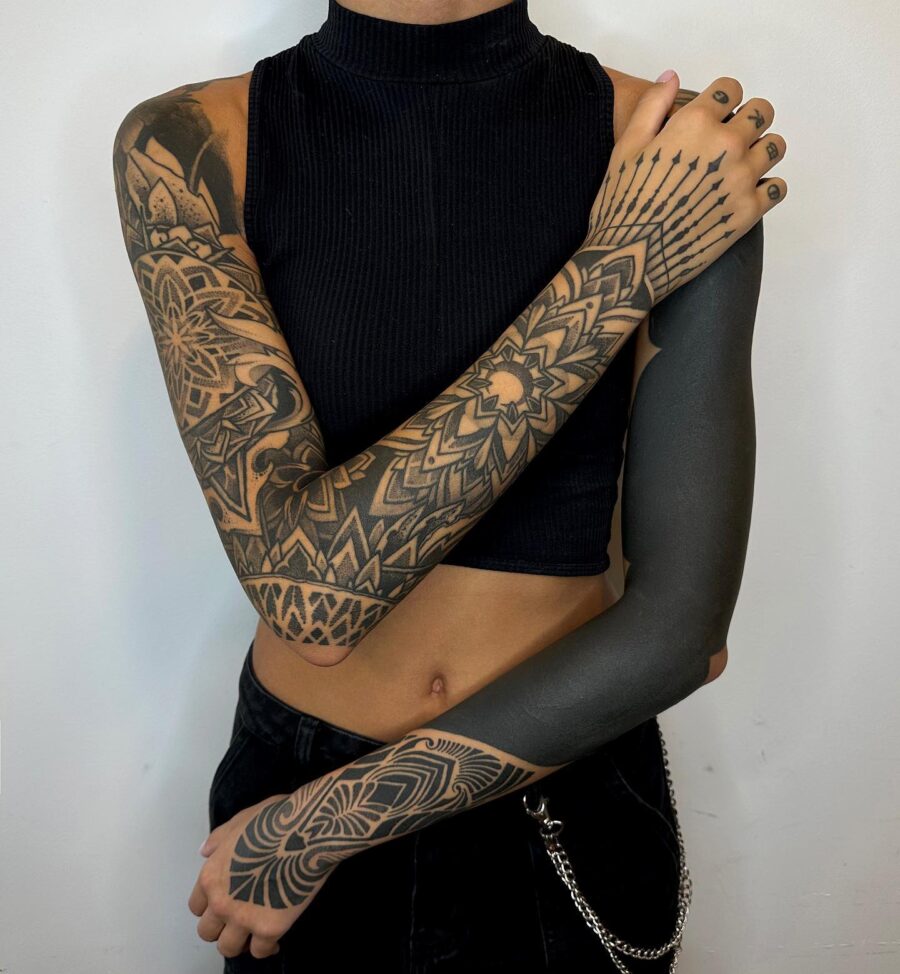 Dramatic black sleeve tattoo with intricate patterns
