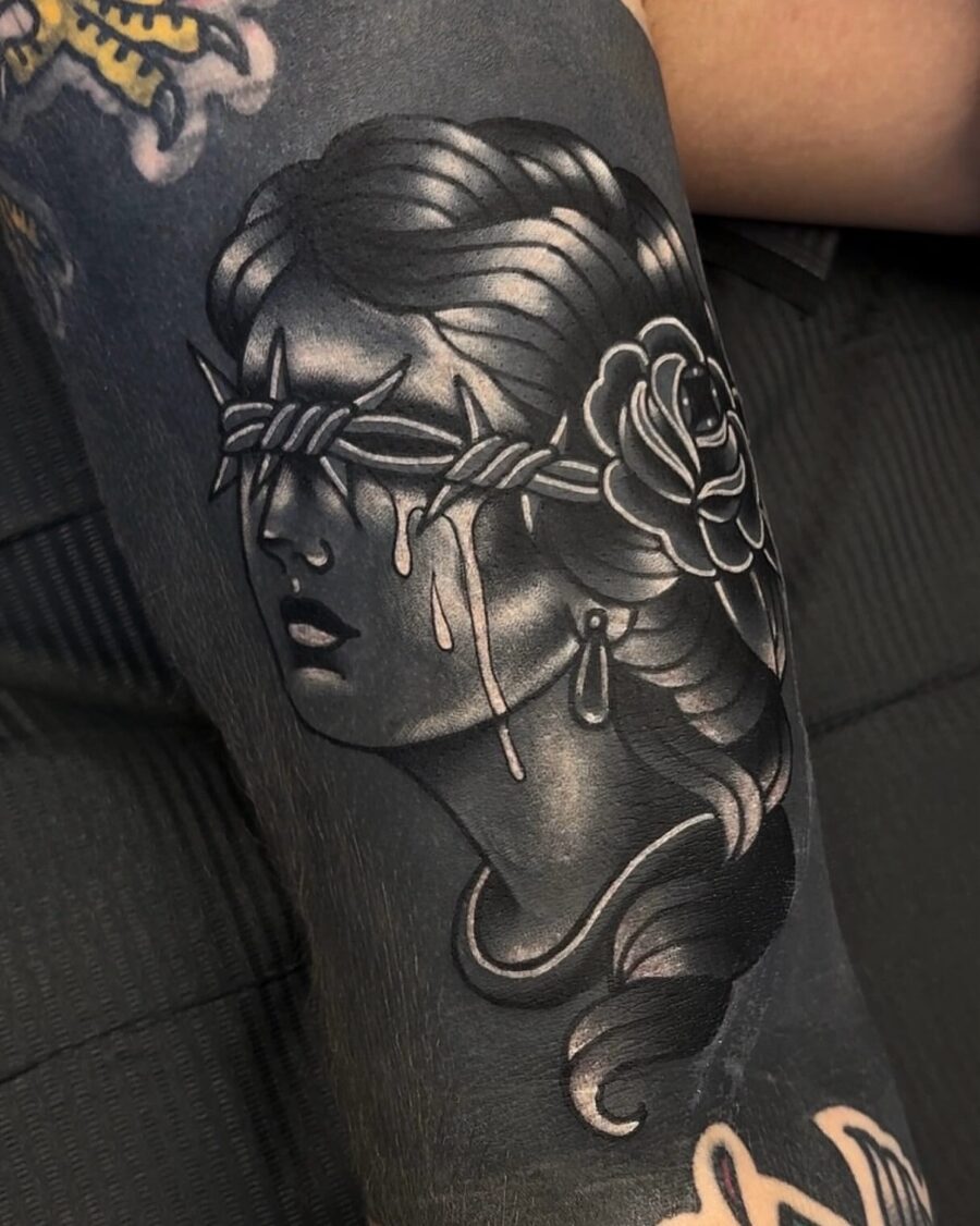 Intriguing blindfolded woman tattoo with rose