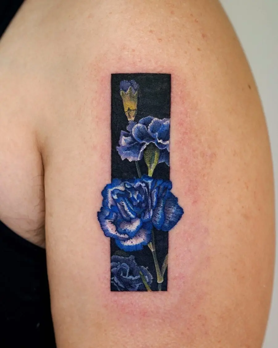 Elegant blue carnation tattoo on arm