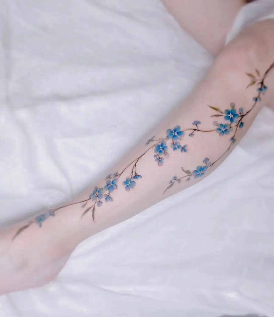 Beautiful blue flower tattoo on the arm