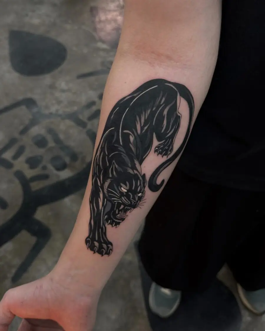 Striking black panther tattoo design on arm