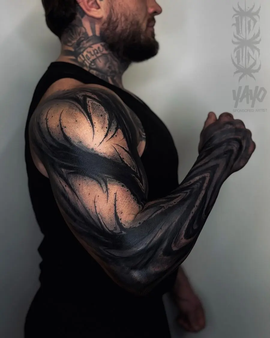 Bold and intricate black sleeve tattoo design