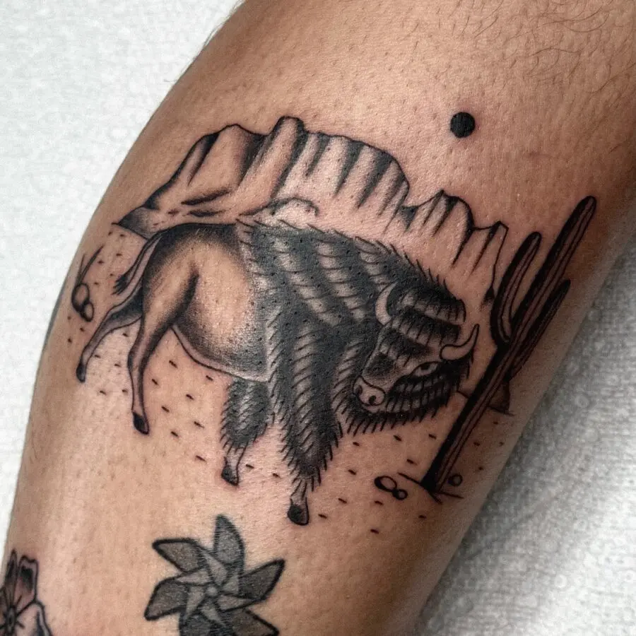 Bold buffalo tattoo with scenic Western elements