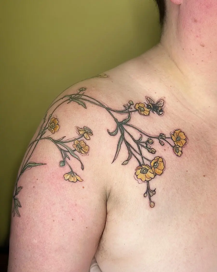 Delicate buttercup floral tattoo with butterfly accent