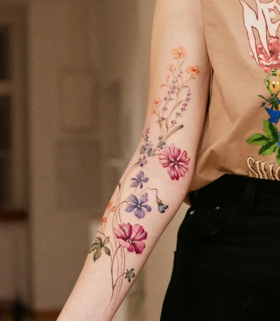 Colorful Blend of Floral Tattoos on Arm