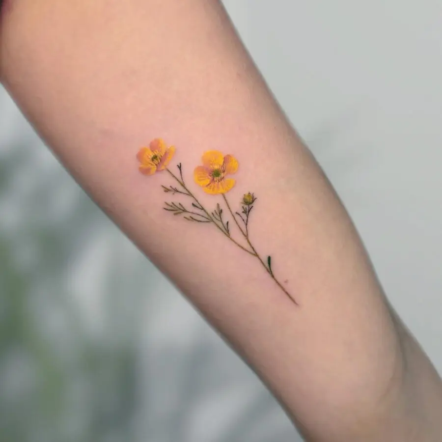 Elegant yellow buttercup flower tattoo on arm