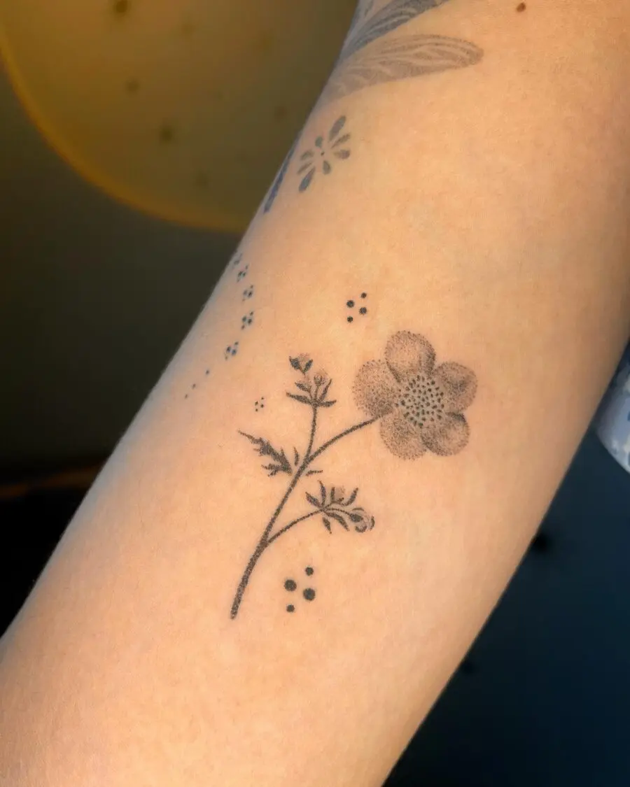 Delicate buttercup flower tattoo design on skin