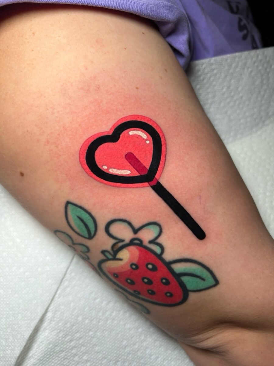 Playful heart-shaped lollipop tattoo design