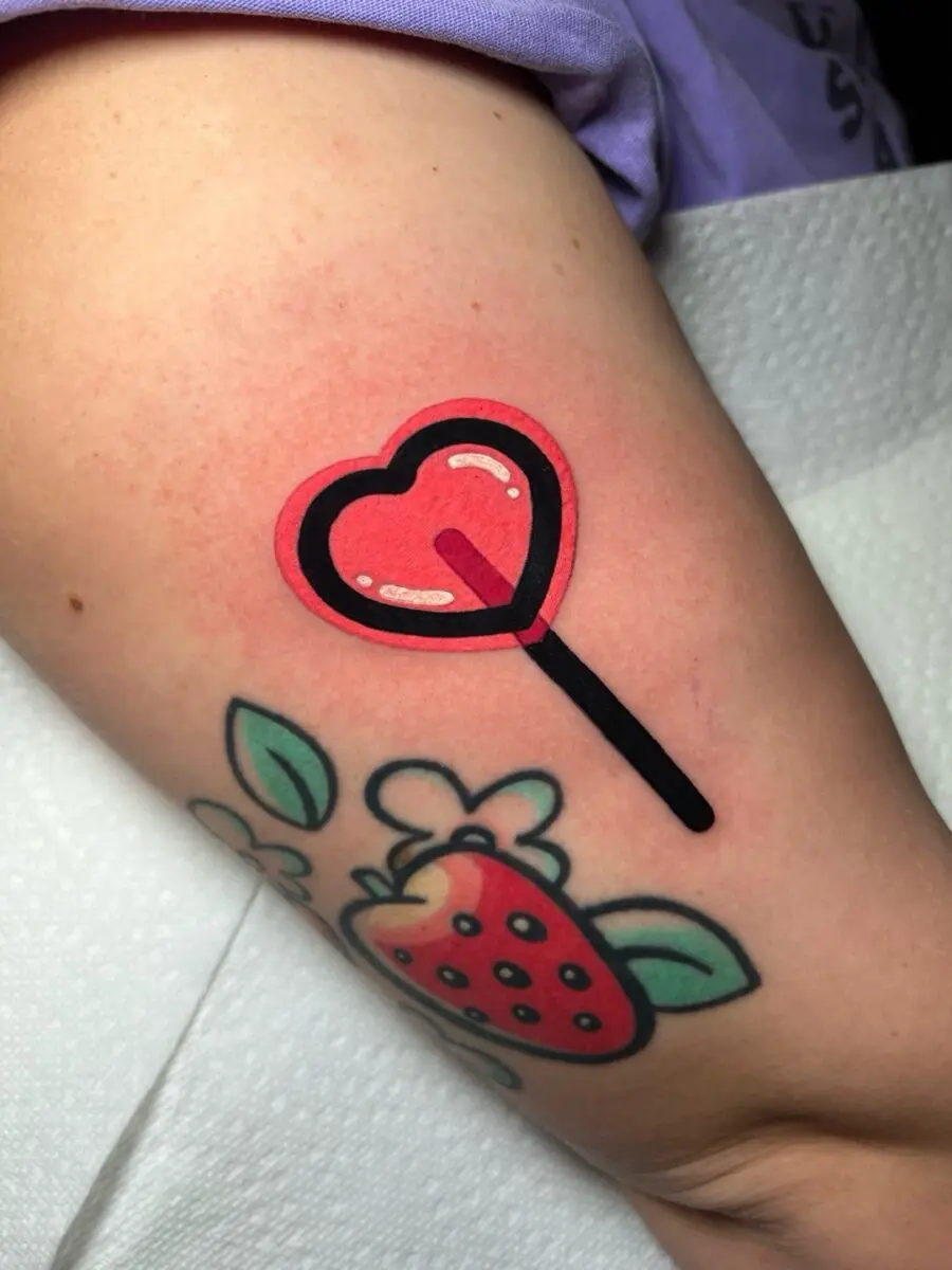 Playful heart-shaped lollipop tattoo design