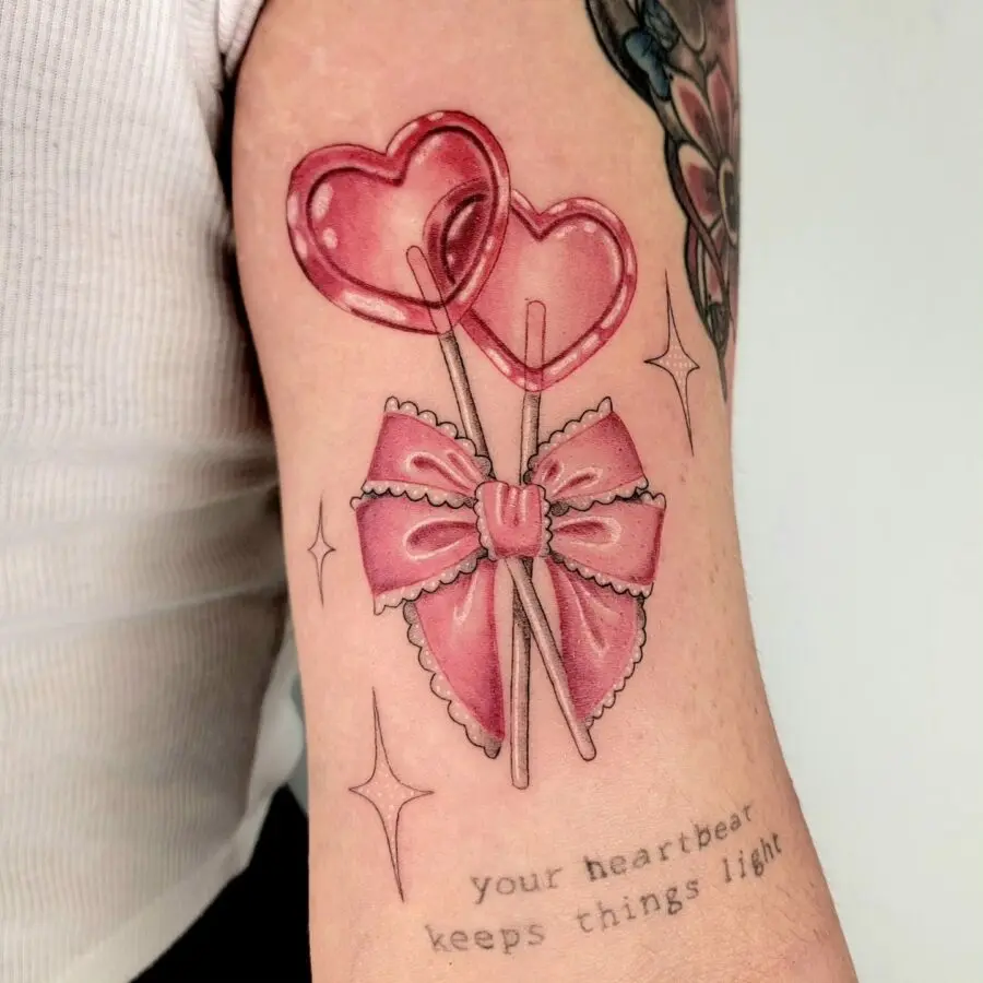Whimsical candy heart tattoo with a bow