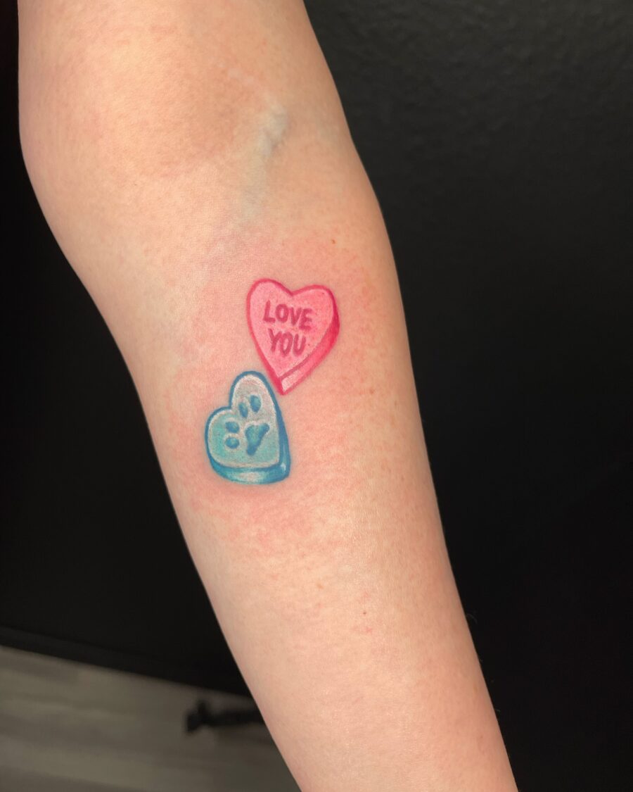 Playful candy heart tattoo with sweet message