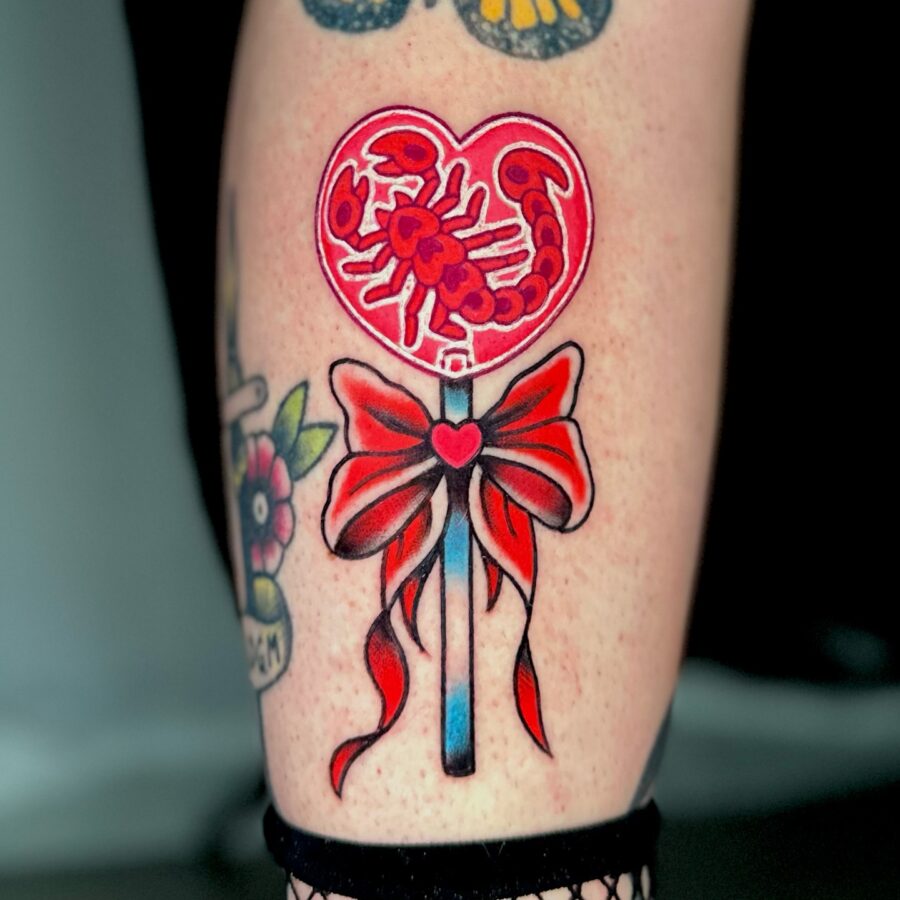 Vibrant candy heart tattoo with scorpion design