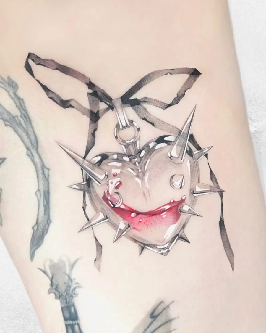 Unique spiked candy heart tattoo with red accents