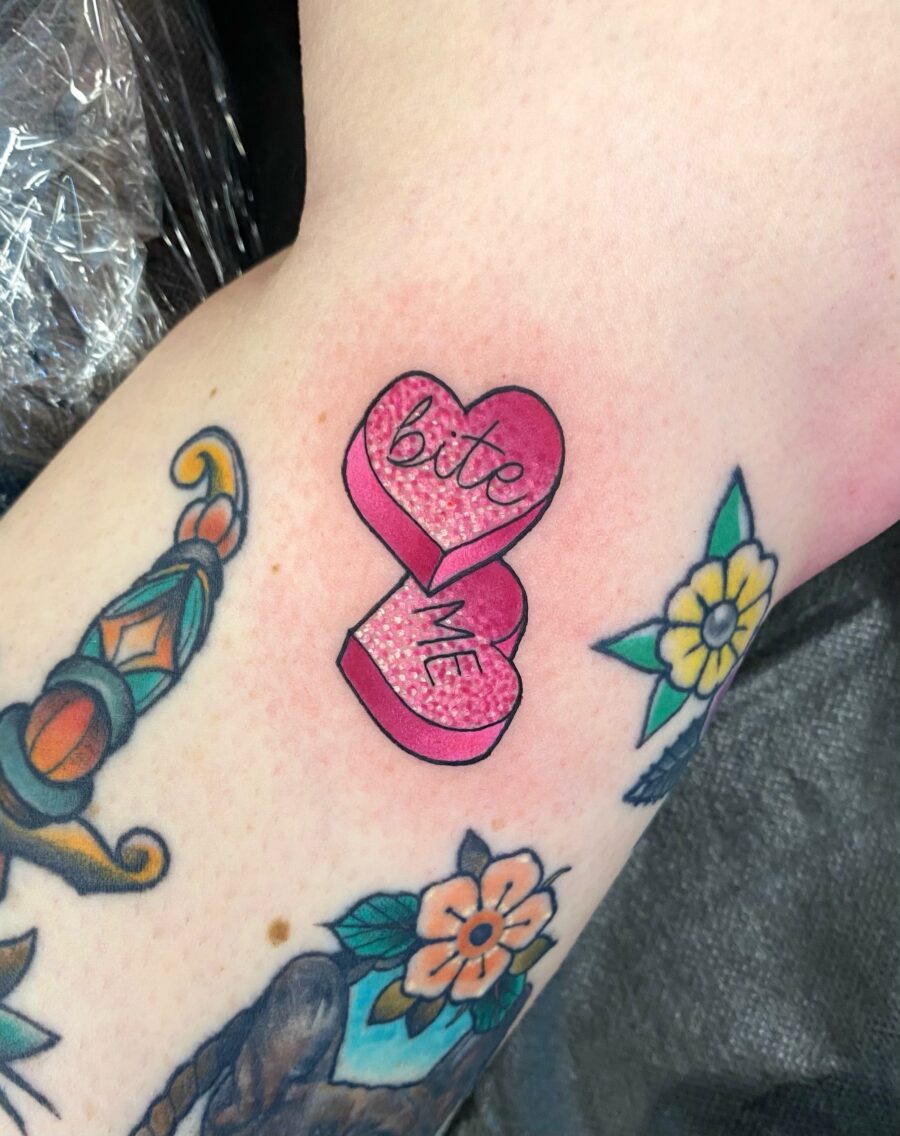 Playful pink candy heart tattoo vibe