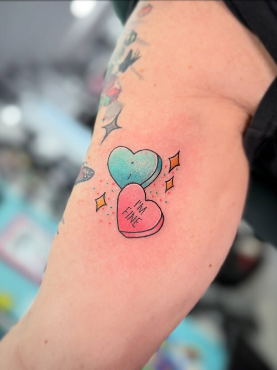 Charming candy heart tattoo with playful vibes
