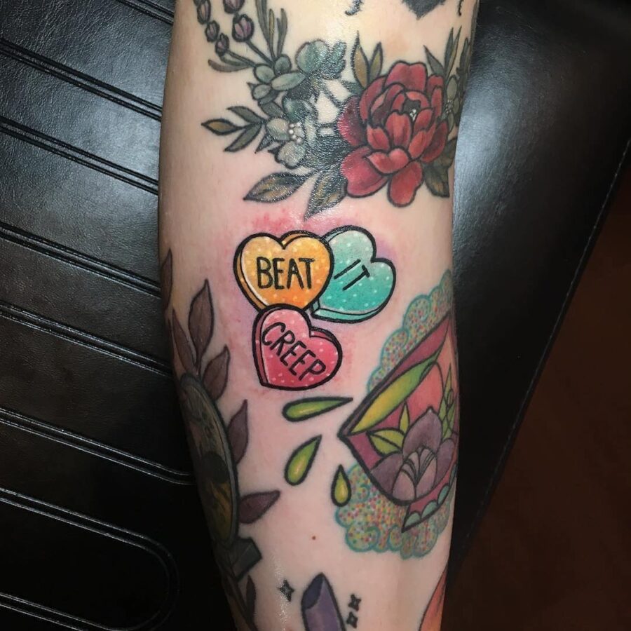 Whimsical candy heart tattoos with bold messages
