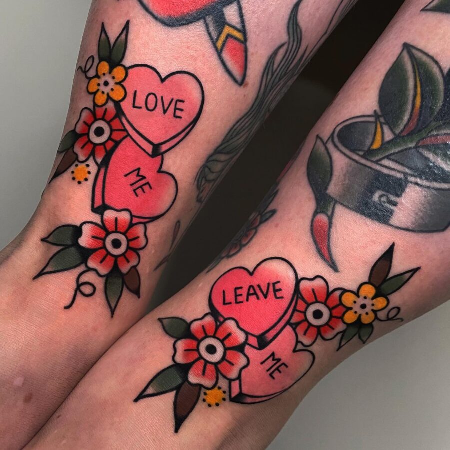 Romantic candy heart tattoos with floral accents