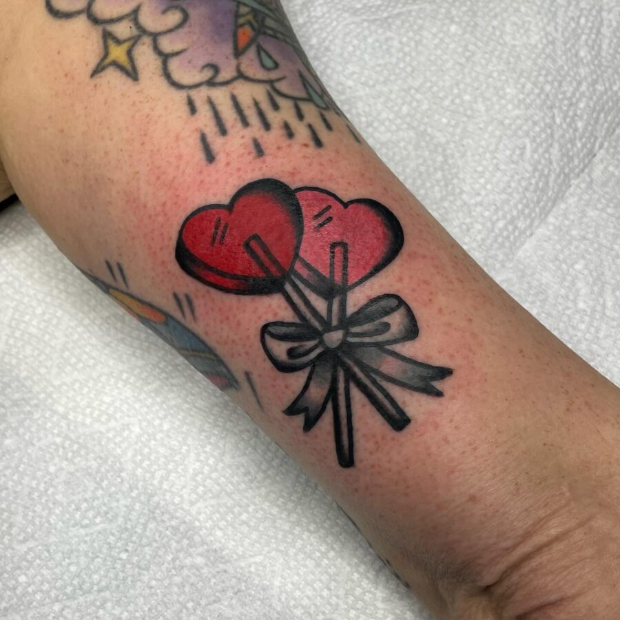 Charming candy heart tattoo with balloon vibes