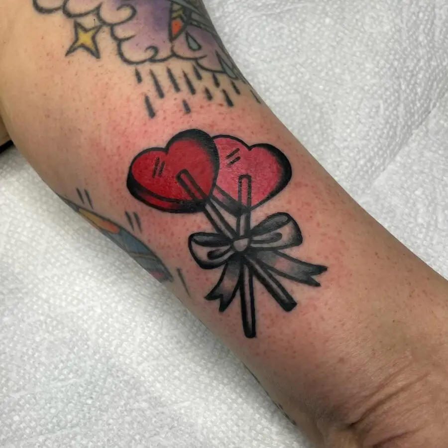 Charming candy heart tattoo with balloon vibes
