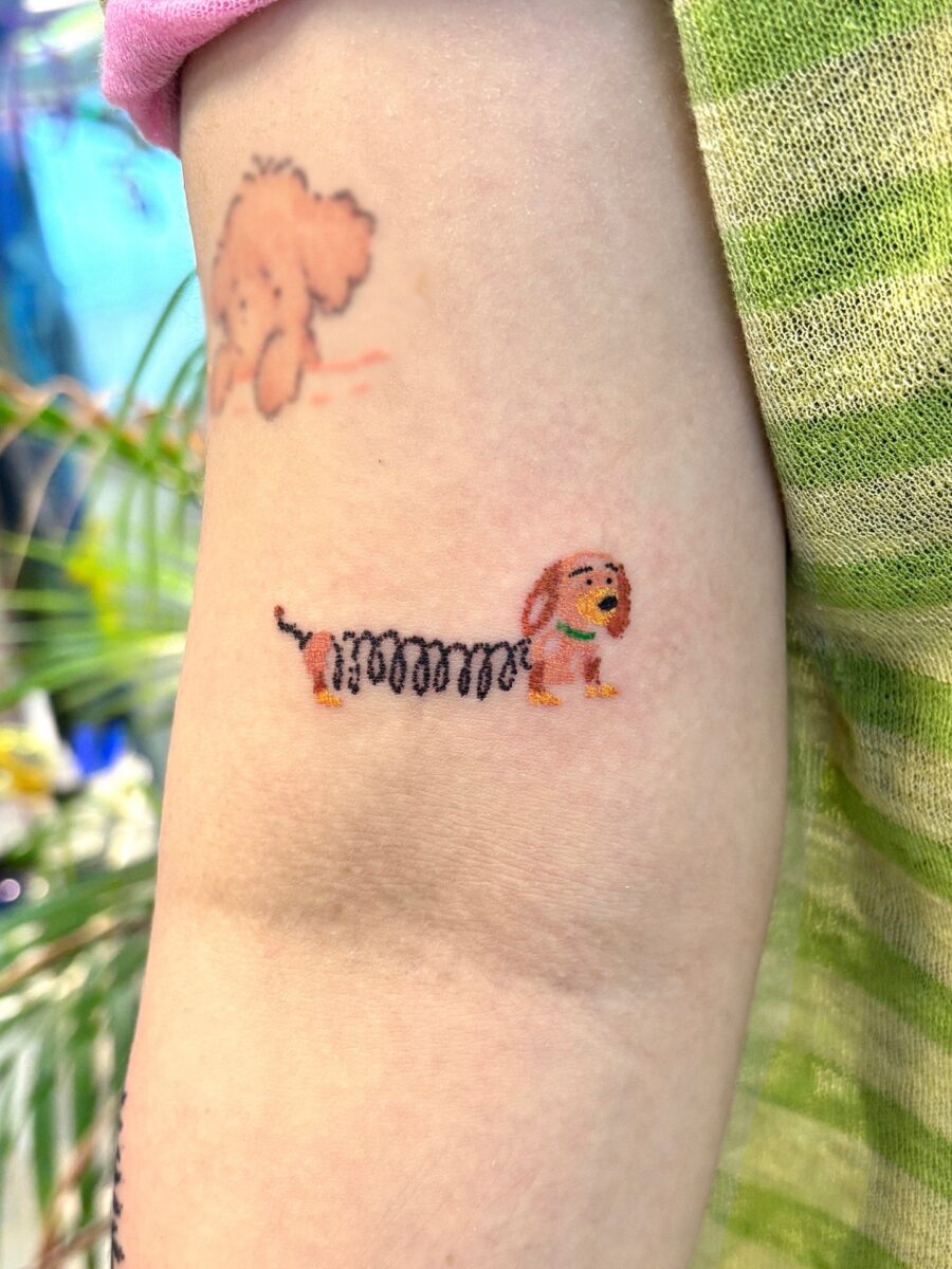 Quirky Cartoon Dog Tattoo with Fun Vibes