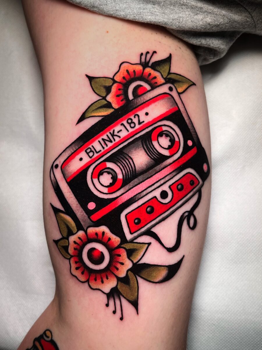 Vibrant cassette tattoo with floral accents