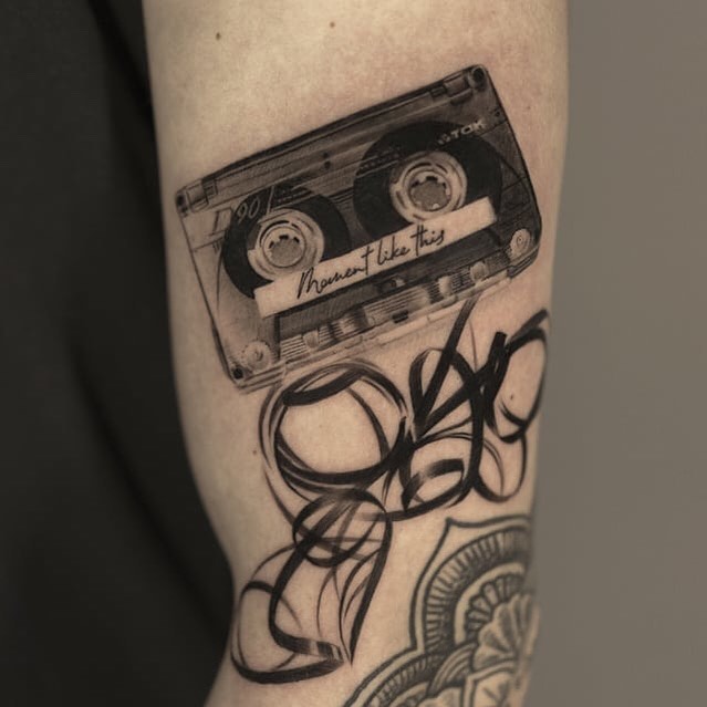 Realistic cassette tape tattoo with artistic flair