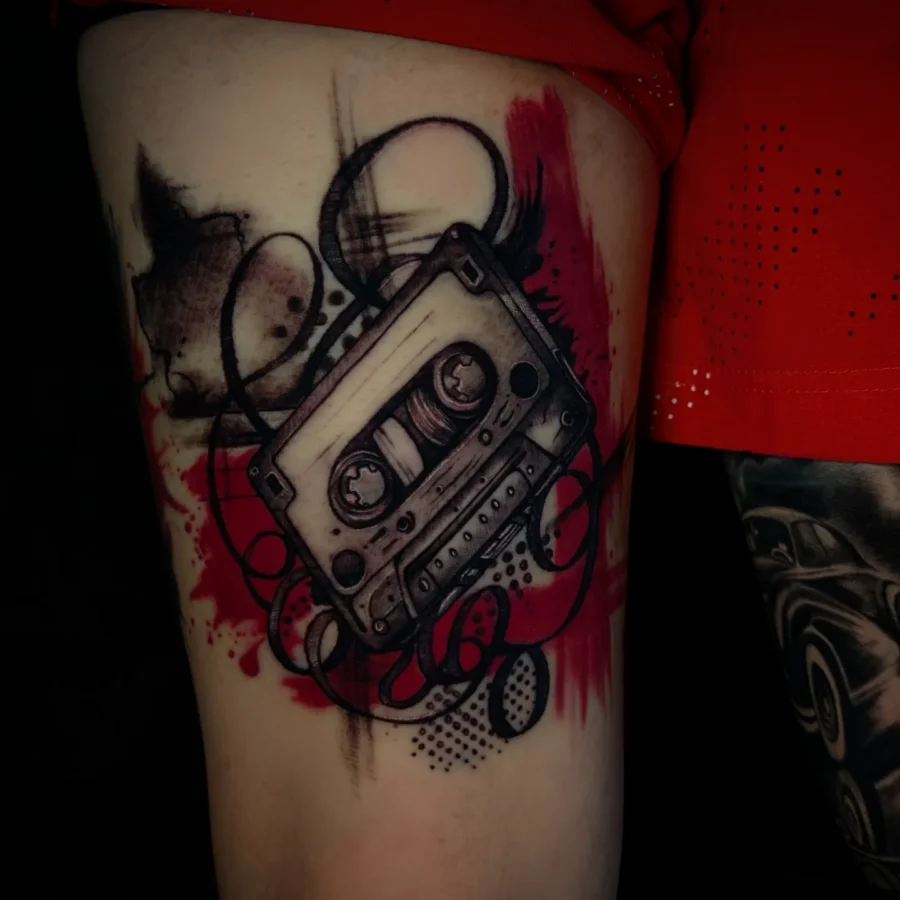 Stylish black and red cassette tape tattoo