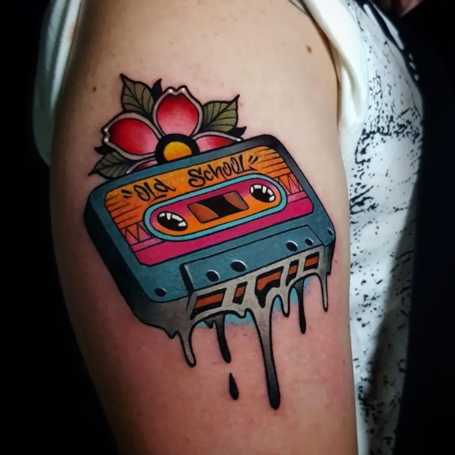 Vibrant cassette tape tattoo with floral details