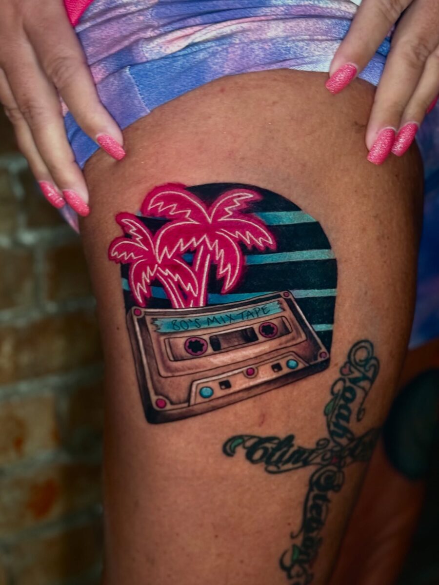 Vibrant cassette tattoo with palm tree vibes