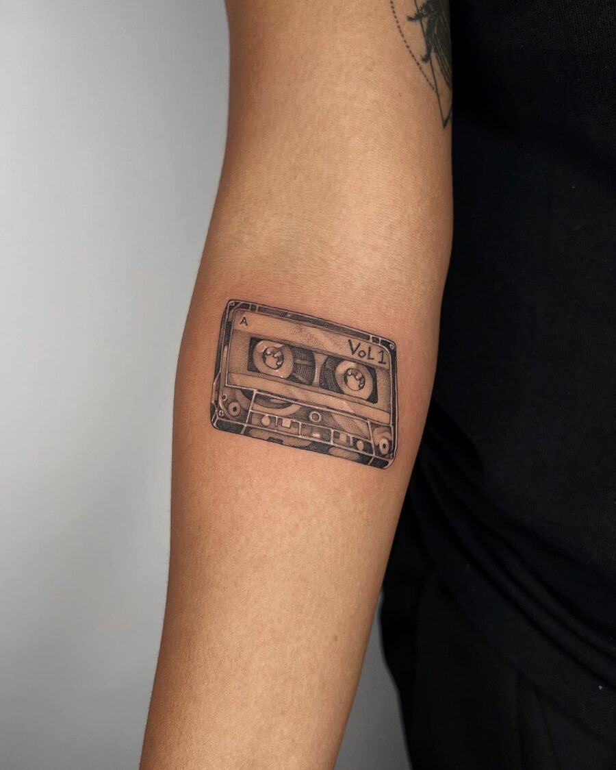 Realistic cassette tape tattoo on forearm