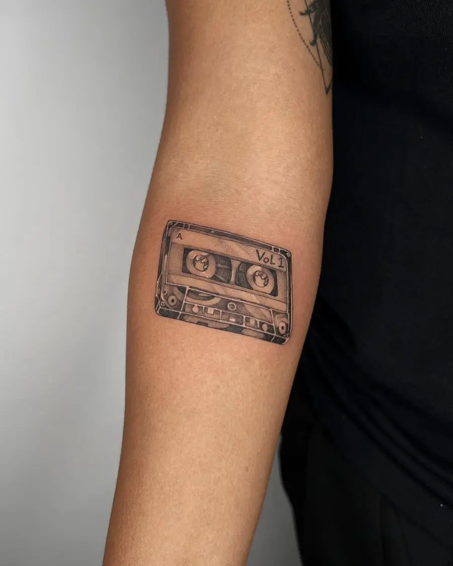 Realistic cassette tape tattoo on forearm