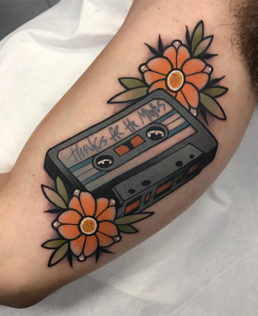 Colorful cassette tattoo adorned with flowers
